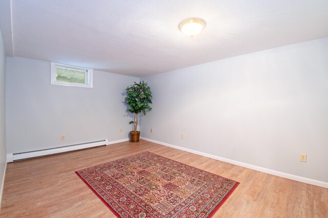 empty room featuring light hardwood / wood-style flooring and baseboard heating