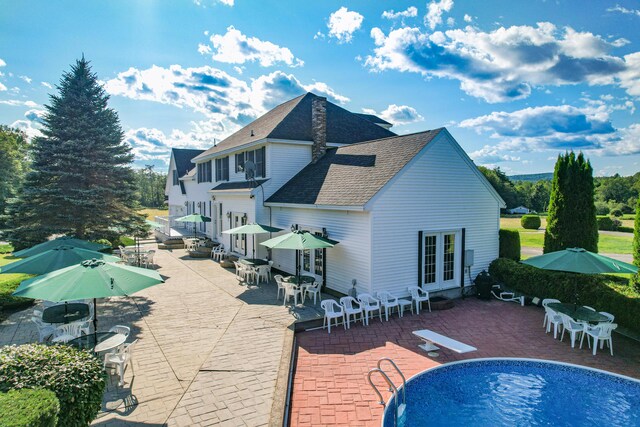 rear view of property with french doors and a patio