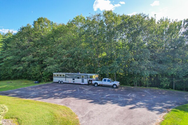 view of vehicle parking with a yard