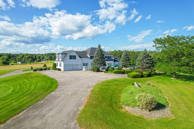 view of front of property with a garage and a front lawn