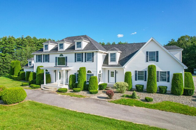 view of front of house with a front yard and a porch