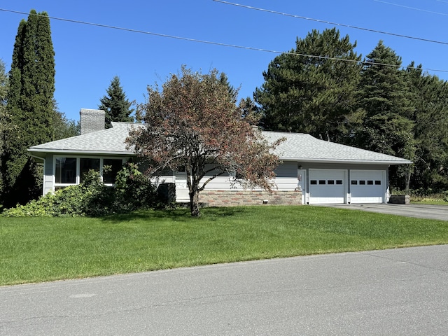 view of front facade with a garage and a front lawn