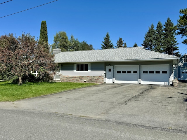 single story home featuring a garage and a front yard