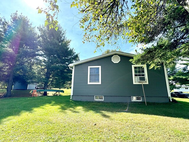 view of side of home featuring a lawn