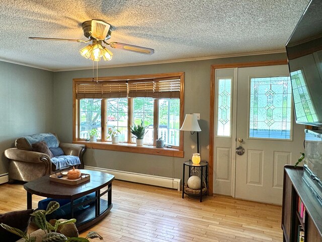 interior space with light wood-type flooring, a textured ceiling, a baseboard radiator, and ceiling fan