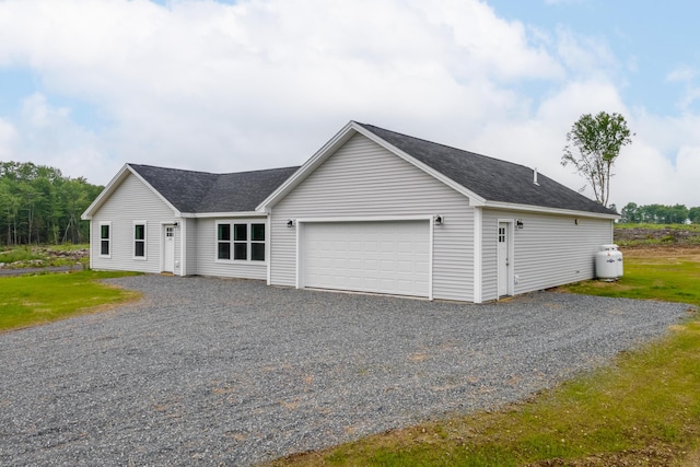 268 Merrill Rd, Levant, ME 04456 - view of front of house with roof with shingles, an attached garage, and gravel driveway
