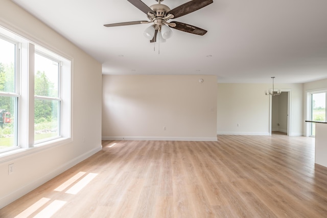 268 Merrill Rd, Levant, ME 04456 - unfurnished room featuring baseboards, light wood-style flooring, a chandelier, and a ceiling fan