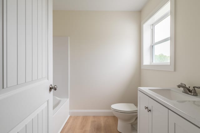 268 Merrill Rd, Levant, ME 04456 - full bath featuring vanity, toilet, wood finished floors, baseboards, and a tub