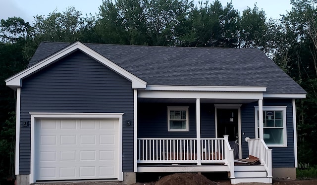 view of front facade with a garage and a porch