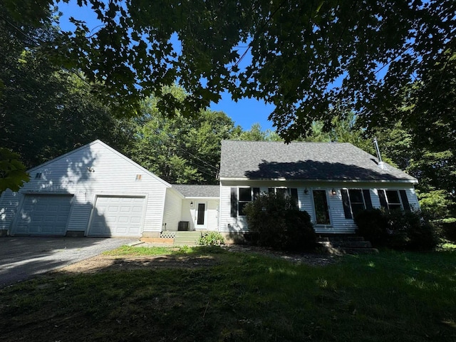 view of front of property with a garage and a front yard