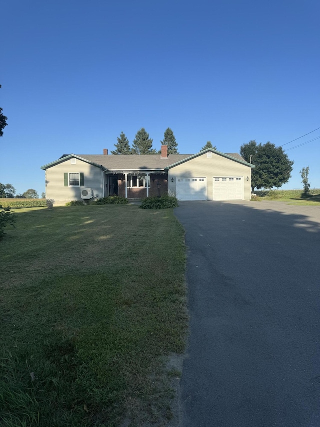 ranch-style house with a garage and a front yard