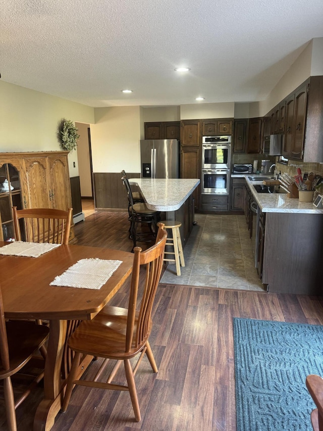 265 Main Rd, Bradford, ME 04410 - kitchen featuring a center island, light countertops, appliances with stainless steel finishes, a sink, and dark brown cabinets