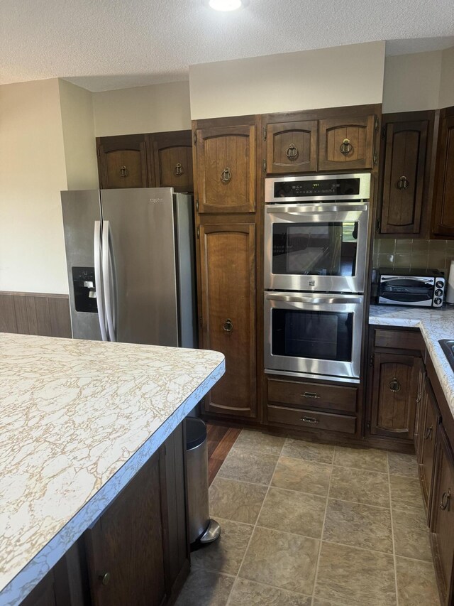 265 Main Rd, Bradford, ME 04410 - kitchen featuring stainless steel appliances, light countertops, and dark brown cabinetry