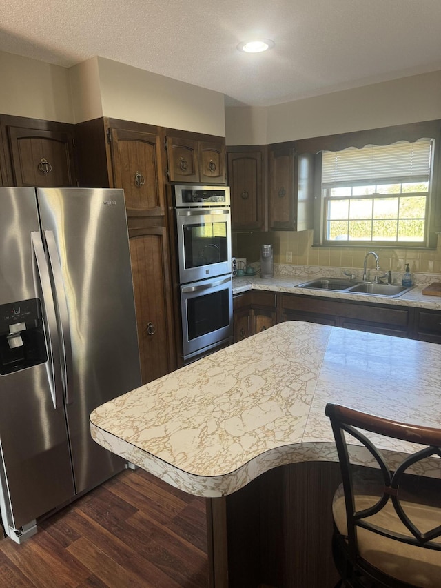 265 Main Rd, Bradford, ME 04410 - kitchen with dark wood finished floors, appliances with stainless steel finishes, light countertops, dark brown cabinets, and a sink