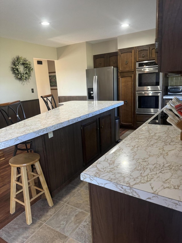 265 Main Rd, Bradford, ME 04410 - kitchen with a breakfast bar area, recessed lighting, light countertops, appliances with stainless steel finishes, and dark brown cabinets