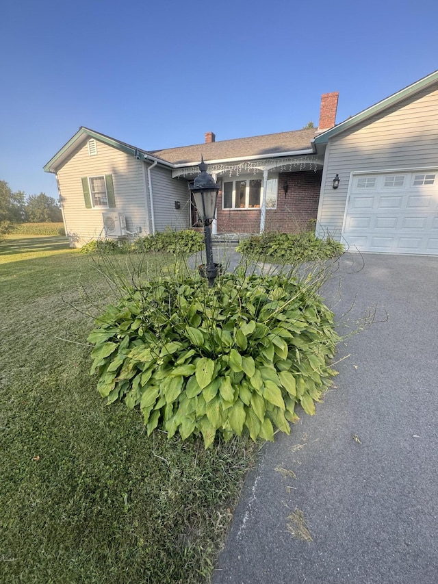 265 Main Rd, Bradford, ME 04410 - ranch-style home with a garage, a front yard, a chimney, and brick siding
