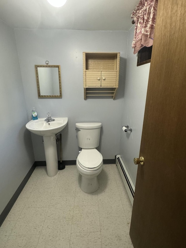 265 Main Rd, Bradford, ME 04410 - bathroom featuring toilet, baseboards, baseboard heating, and tile patterned floors