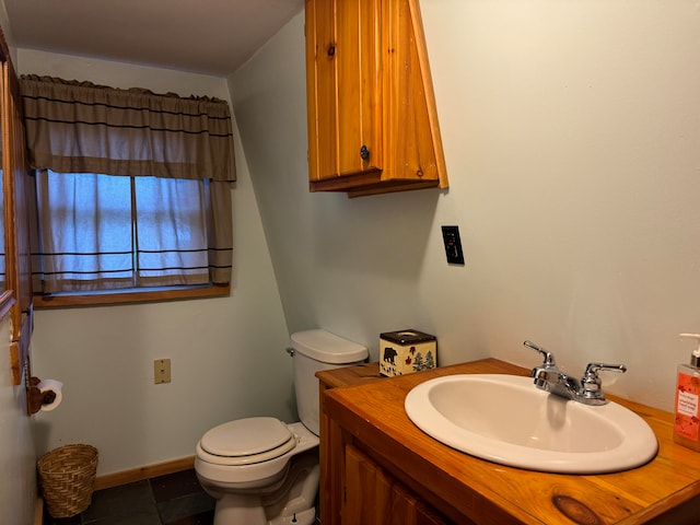 bathroom featuring tile patterned flooring, vanity, and toilet