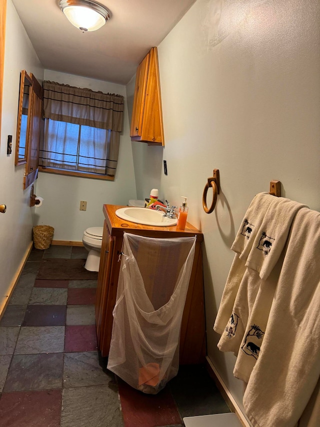 bathroom with toilet and vanity