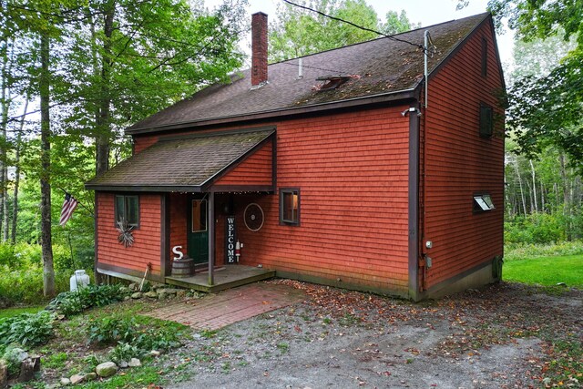 39 Simmons Ln, Friendship, ME 04547 - rear view of house with a chimney and a shingled roof