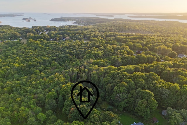 aerial view at dusk featuring a water view