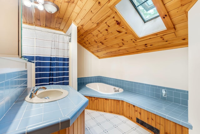 39 Simmons Ln, Friendship, ME 04547 - bathroom with tile patterned floors, wood ceiling, vanity, a garden tub, and lofted ceiling with skylight