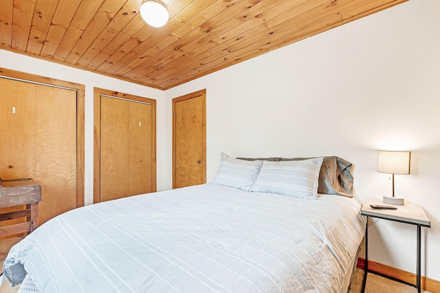 bedroom with two closets and wood ceiling