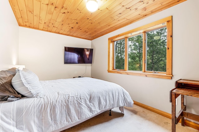 carpeted bedroom featuring lofted ceiling and wooden ceiling