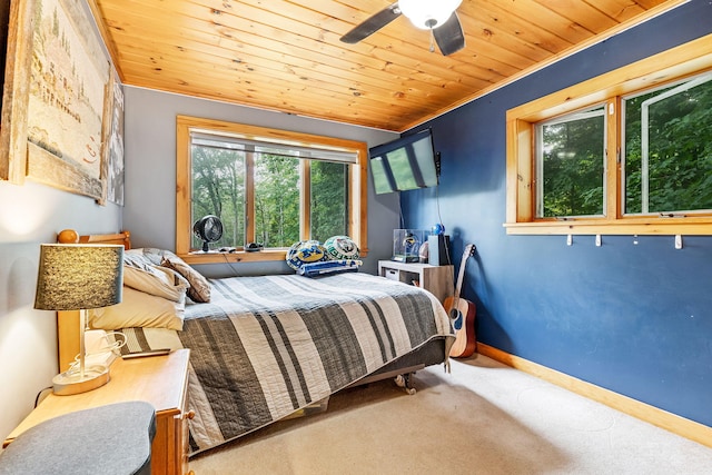 carpeted bedroom featuring wood ceiling, crown molding, and ceiling fan