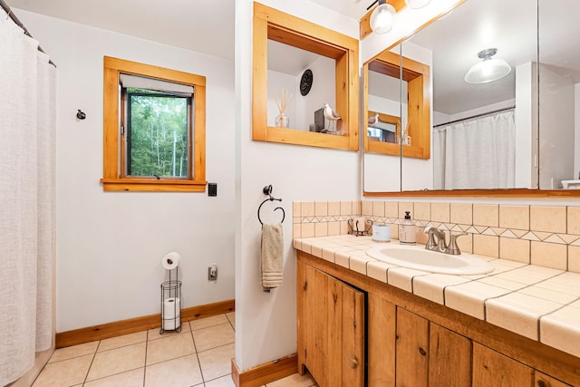 bathroom with tile patterned flooring, vanity, and backsplash