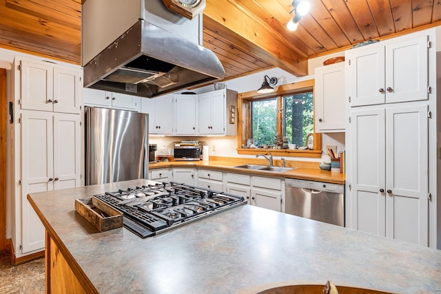 kitchen featuring island range hood, sink, appliances with stainless steel finishes, and white cabinets