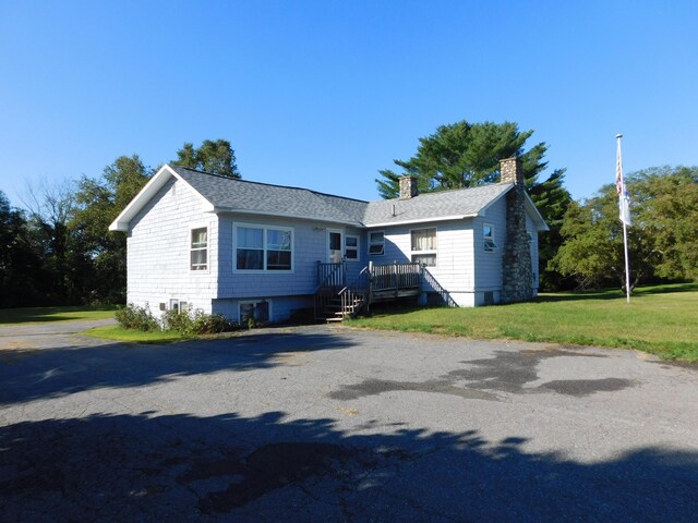 view of property exterior featuring a lawn