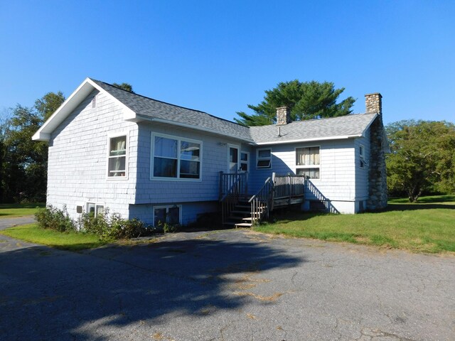 view of side of home with a lawn