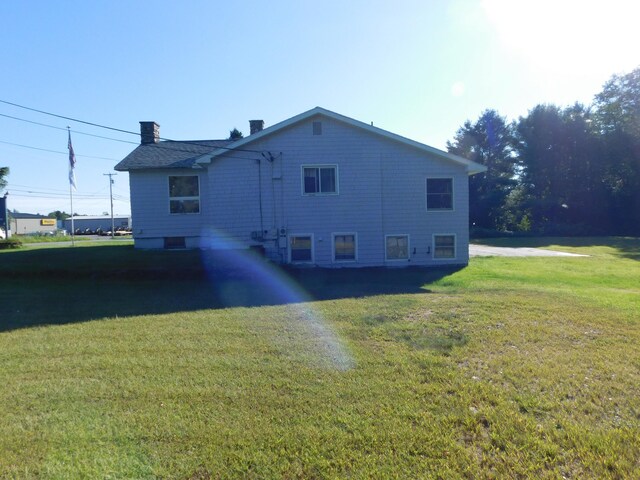 rear view of property with a yard