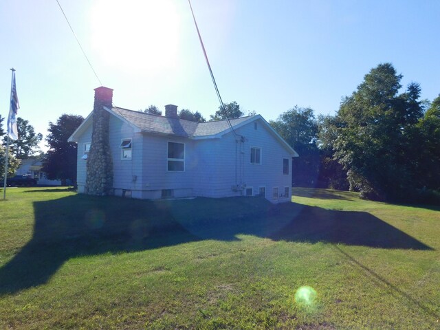 view of property exterior with a yard