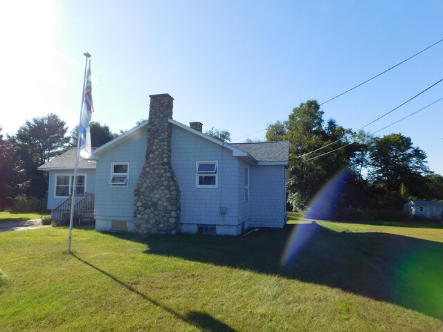 view of side of property with a lawn