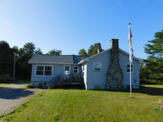 back of house with a lawn