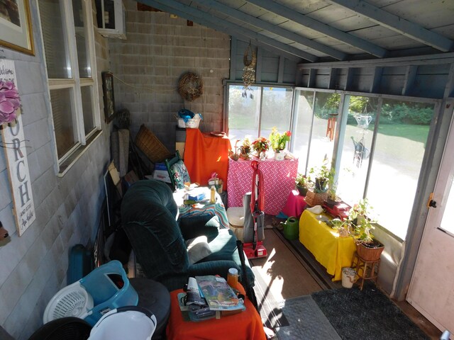 sunroom / solarium featuring lofted ceiling and a wealth of natural light