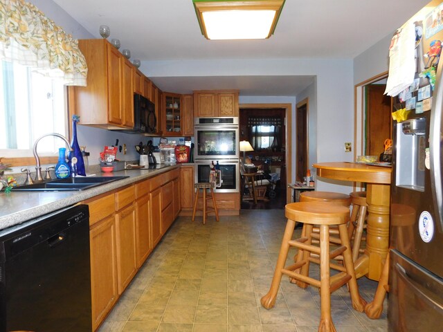 kitchen featuring black appliances and sink