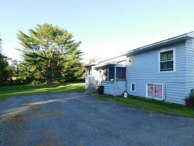 view of home's exterior with a lawn