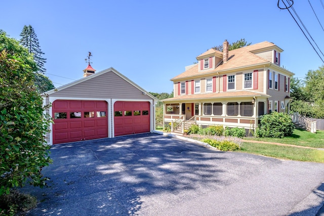 311 Pine St, South Portland, ME 04106 - view of front of home featuring a garage, an outdoor structure, a chimney, and covered porch