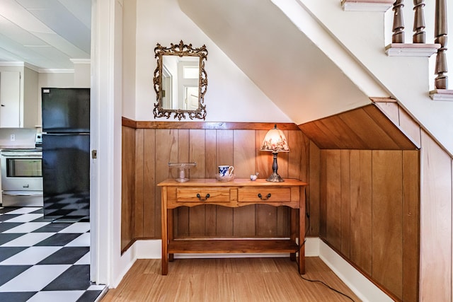 311 Pine St, South Portland, ME 04106 - hall featuring light floors, wooden walls, wainscoting, and vaulted ceiling