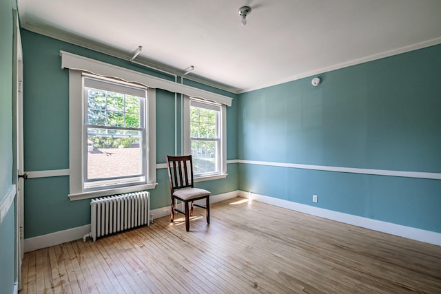 311 Pine St, South Portland, ME 04106 - living area with radiator, ornamental molding, hardwood / wood-style floors, and baseboards