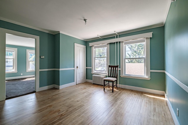 311 Pine St, South Portland, ME 04106 - spare room with radiator heating unit, ornamental molding, hardwood / wood-style flooring, and baseboards