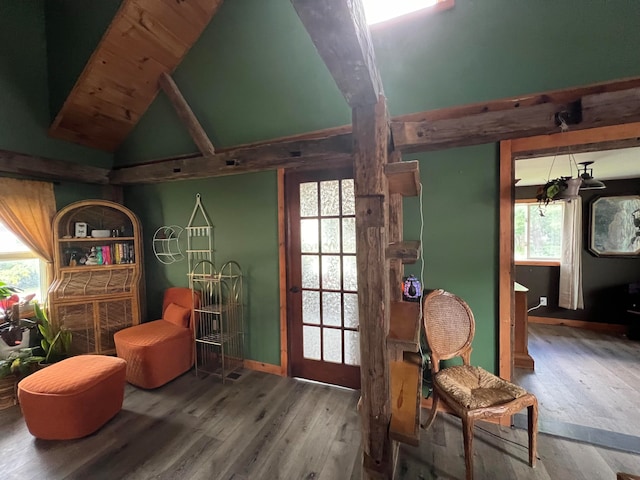 sitting room featuring hardwood / wood-style flooring, a wealth of natural light, and vaulted ceiling