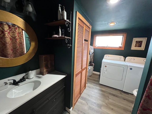 bathroom with toilet, hardwood / wood-style flooring, independent washer and dryer, and vanity