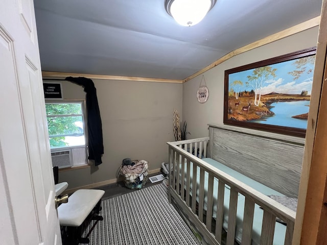 bedroom featuring a nursery area and carpet flooring