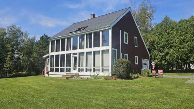 exterior space with a yard and a sunroom