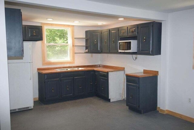 kitchen featuring sink and white appliances