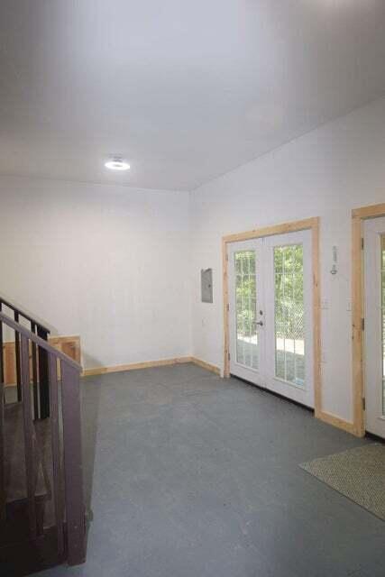 interior space with french doors and concrete floors